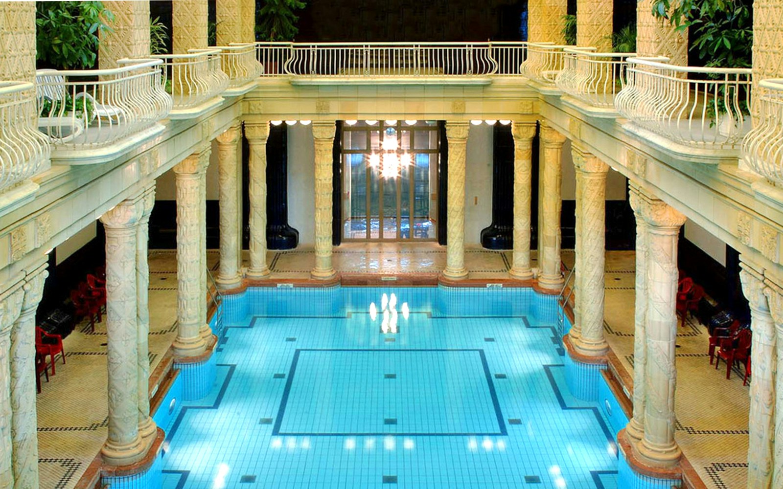 Indoor pool at Gellert Spa, Budapest with ornate columns and arched windows