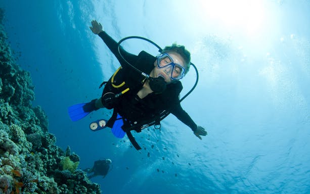 Scuba diver exploring coral reefs in the Red Sea, Hurghada.