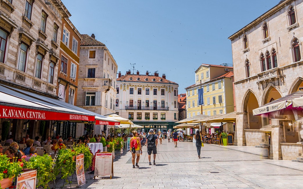 Split city square with cafes and historic buildings on a private walking tour near Diocletian's Palace.