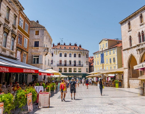 Split city square with cafes and historic buildings on a private walking tour near Diocletian's Palace.
