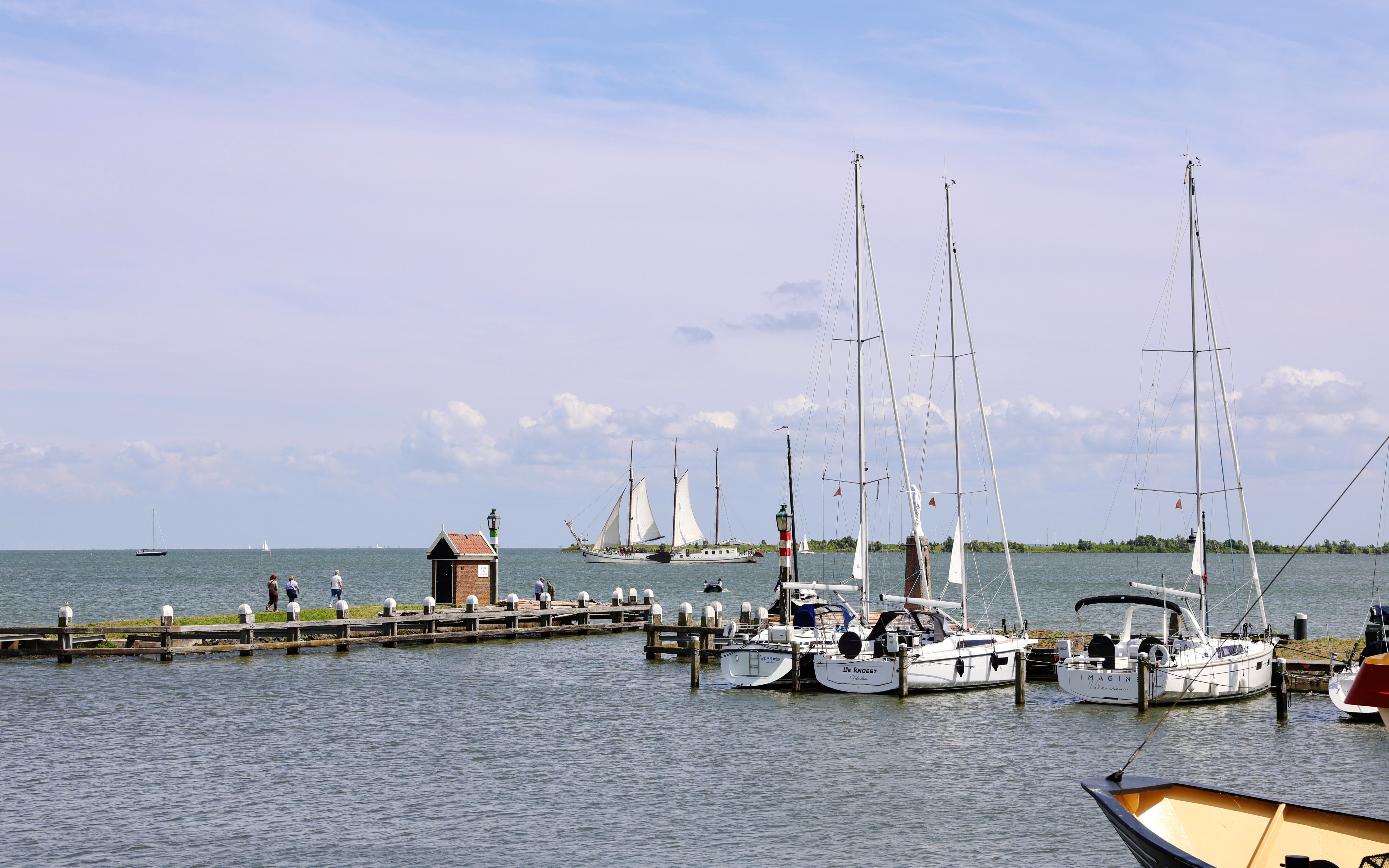 Volendam Harbor with sailboats and a pier during daytime.