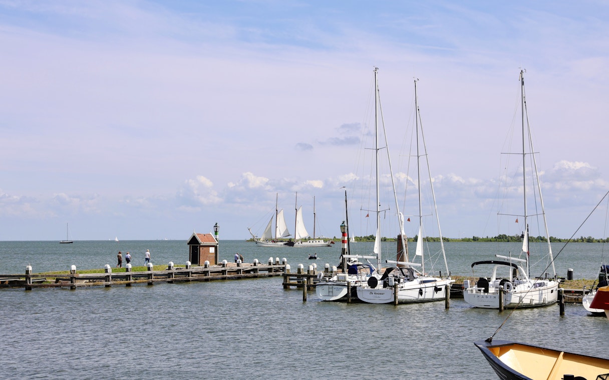 Volendam Harbor with sailboats and a pier during daytime.