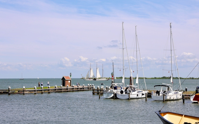 Volendam Harbor with sailboats and a pier during daytime.