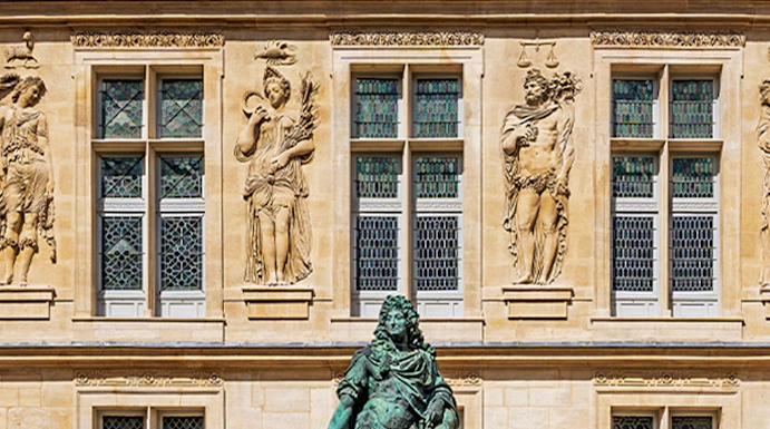 Statue of Louis XIV in front of the Carnavalet Museum, Paris facade.
