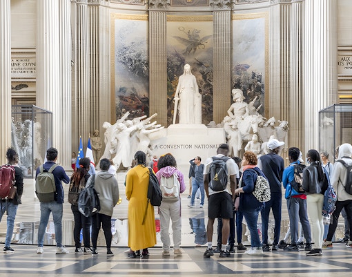 Visitors exploring the interior of the Paris Pantheon, admiring its grand architecture.