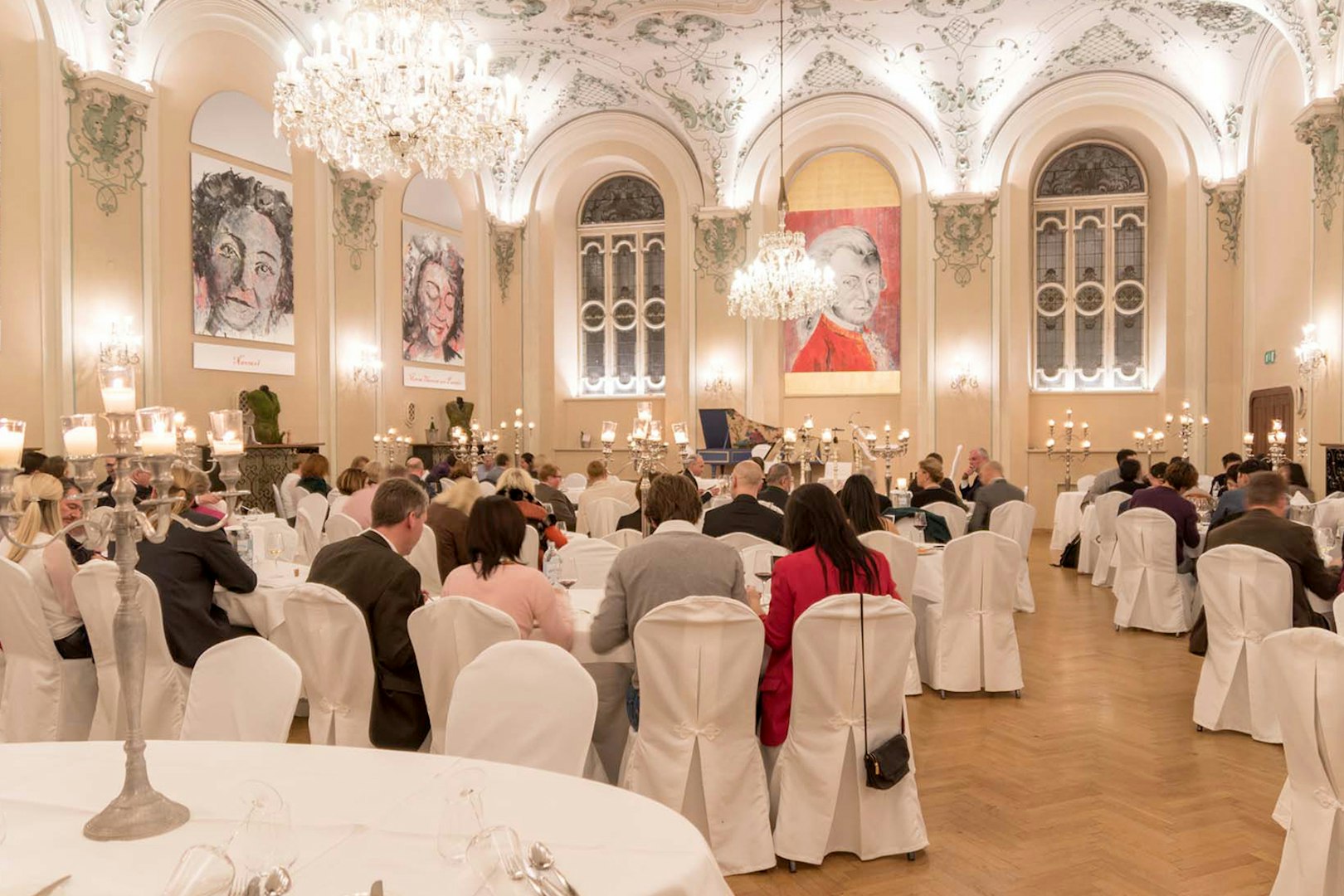 Musicians in period costumes performing at a Mozart concert in a historic Salzburg venue.