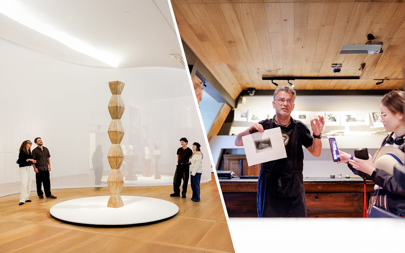 Visitors exploring art and a guide demonstrating a print at Rembrandt House Museum.