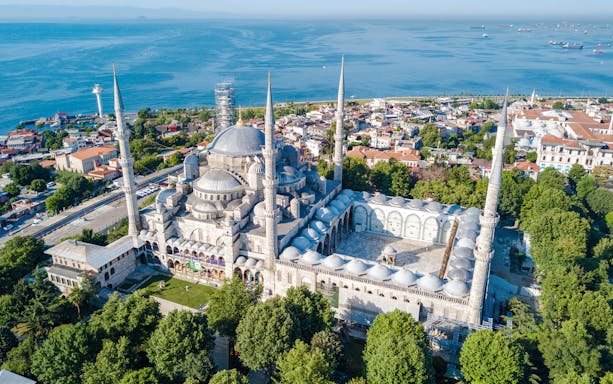 Aerial view of the Blue Mosque Sultanahmet with minarets in Istanbul, overlooking the sea.