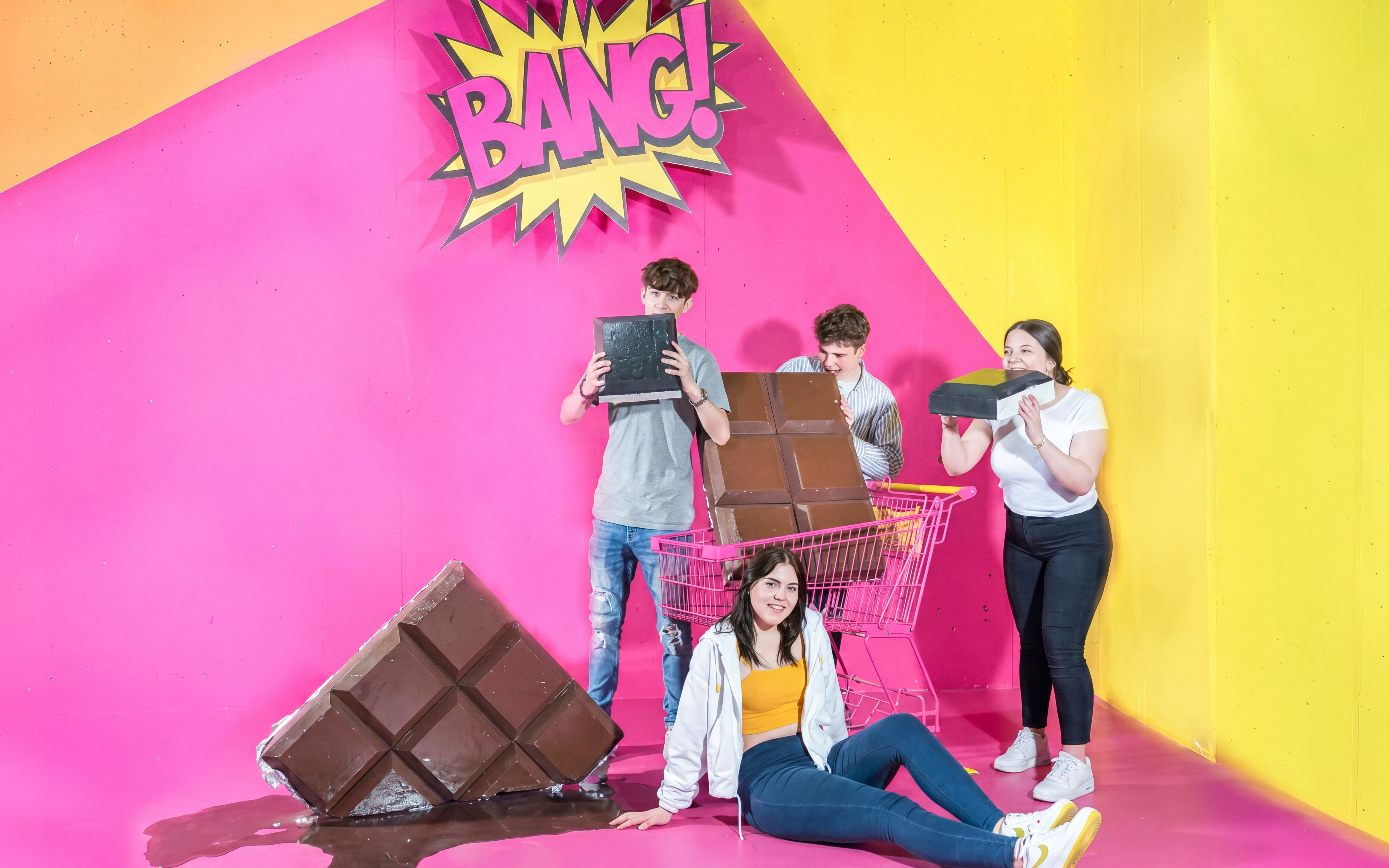 Visitors enjoying oversized chocolate bars at the Chocolate Museum Vienna.