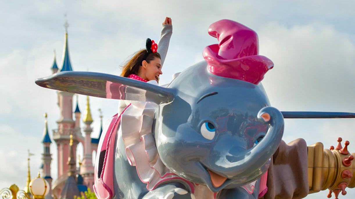 Dumbo the Flying Elephant ride with castle backdrop at Disneyland Paris.