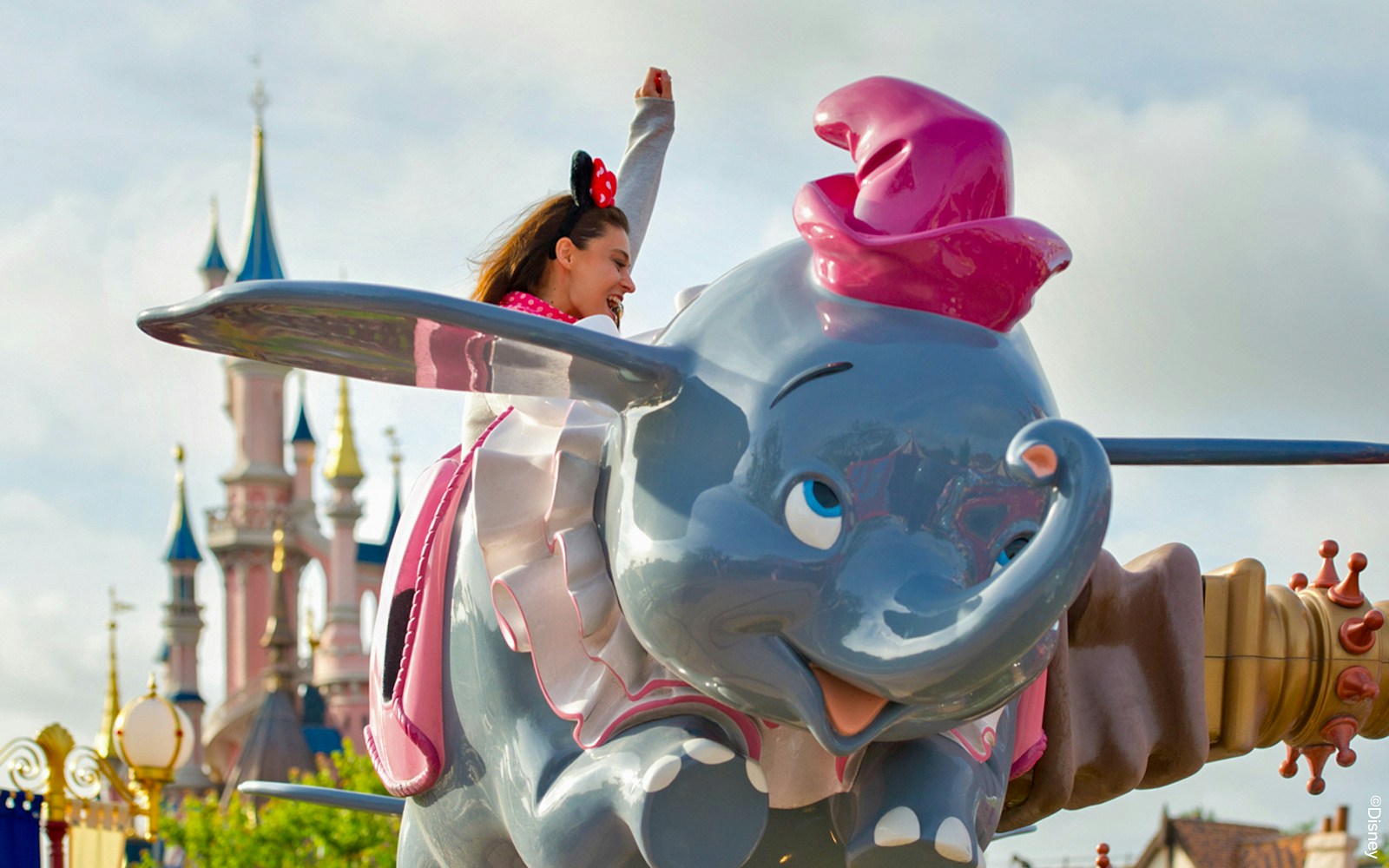 Dumbo the Flying Elephant ride at Disneyland Paris with colorful elephants in motion.