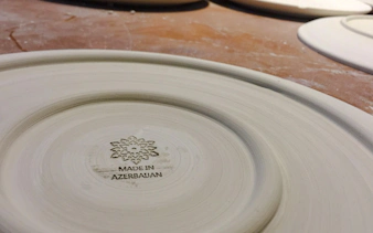 Pottery plate with "Made in Azerbaijan" mark at Baku workshop.
