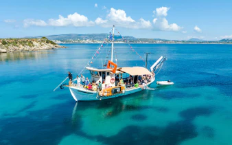 Cruise boat with passengers on clear blue waters near Kefalonia coast.