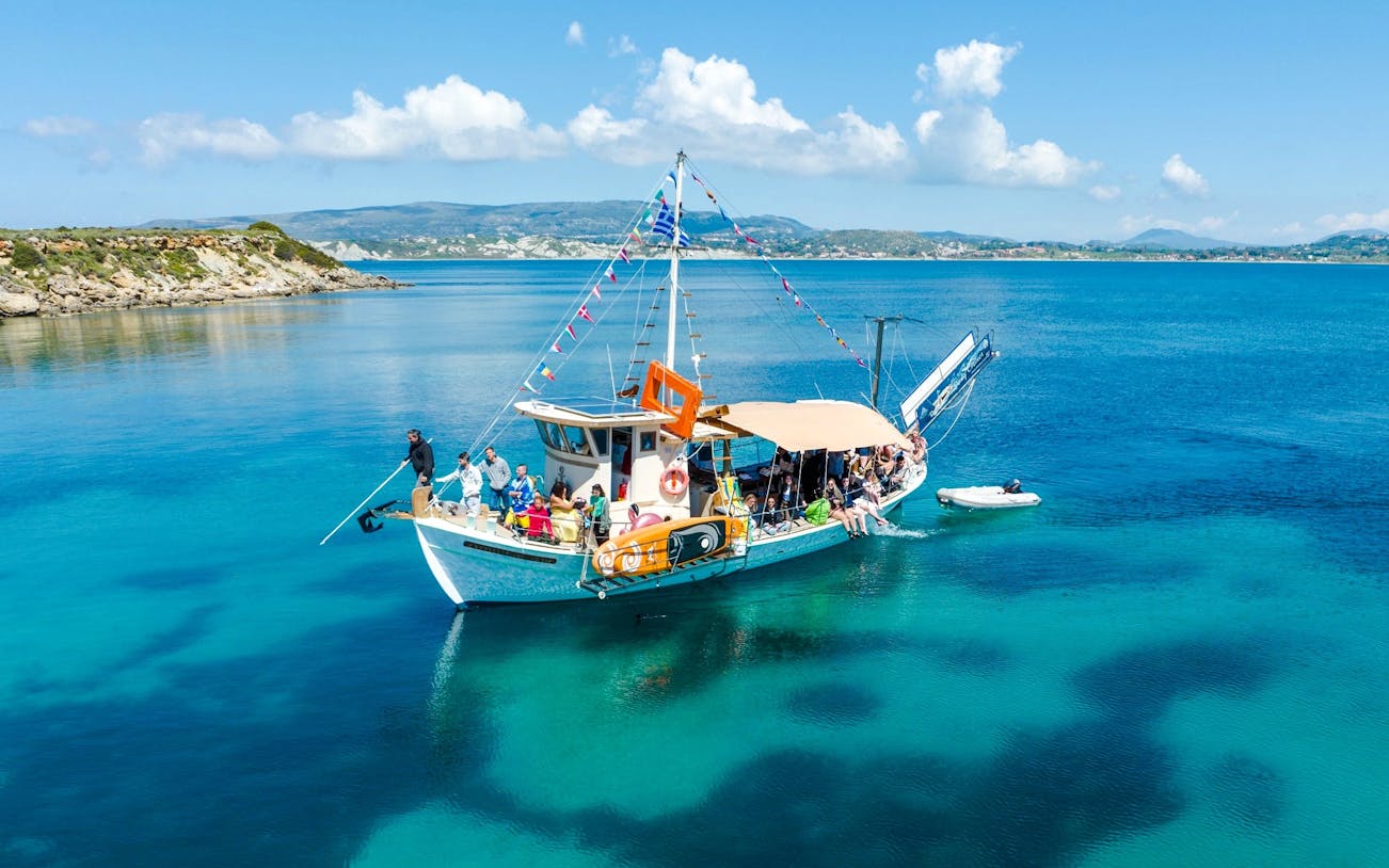 Cruise boat with passengers on clear blue waters near Kefalonia coast.