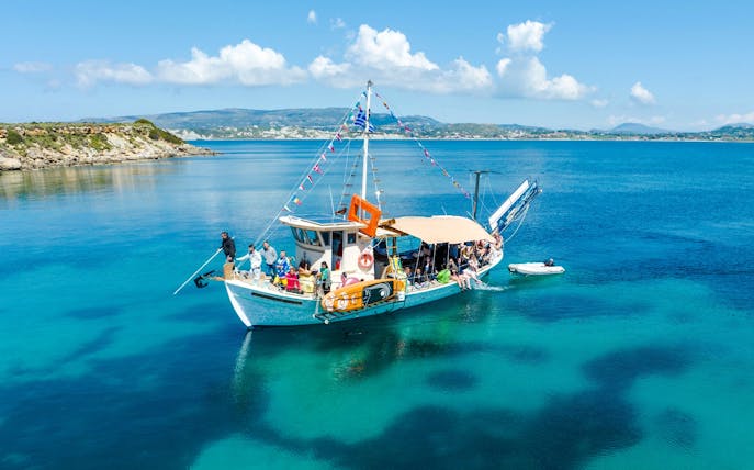 Cruise boat with passengers on clear blue waters near Kefalonia coast.