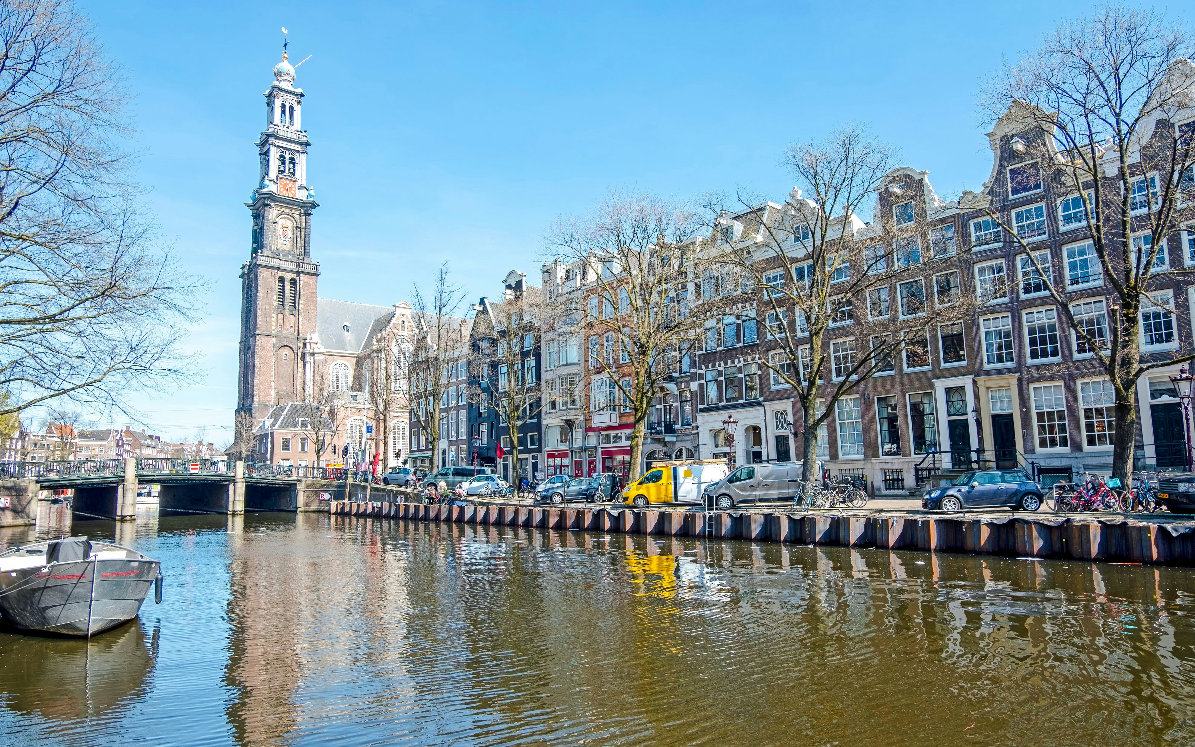 Westerkerk tower and canal view in Amsterdam, Netherlands.