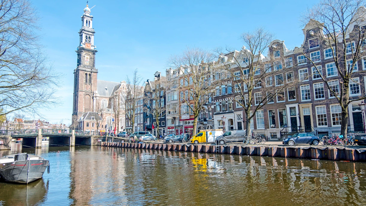Westerkerk tower and canal view in Amsterdam, Netherlands.