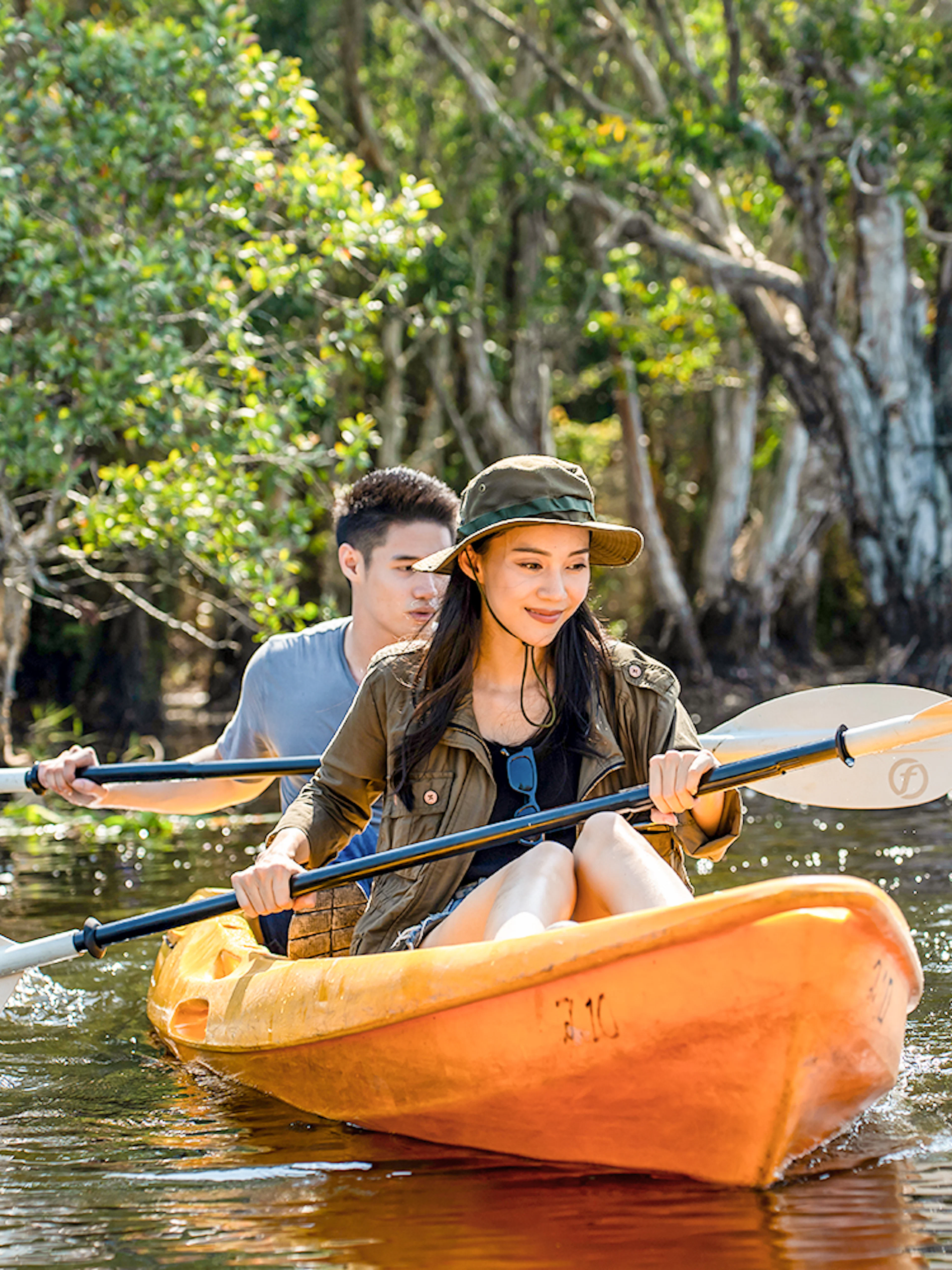 Couple kayaking through Langkawi Mangrove forest.