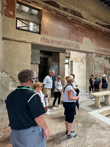 Visitors exploring ancient ruins at Herculaneum, Italy.