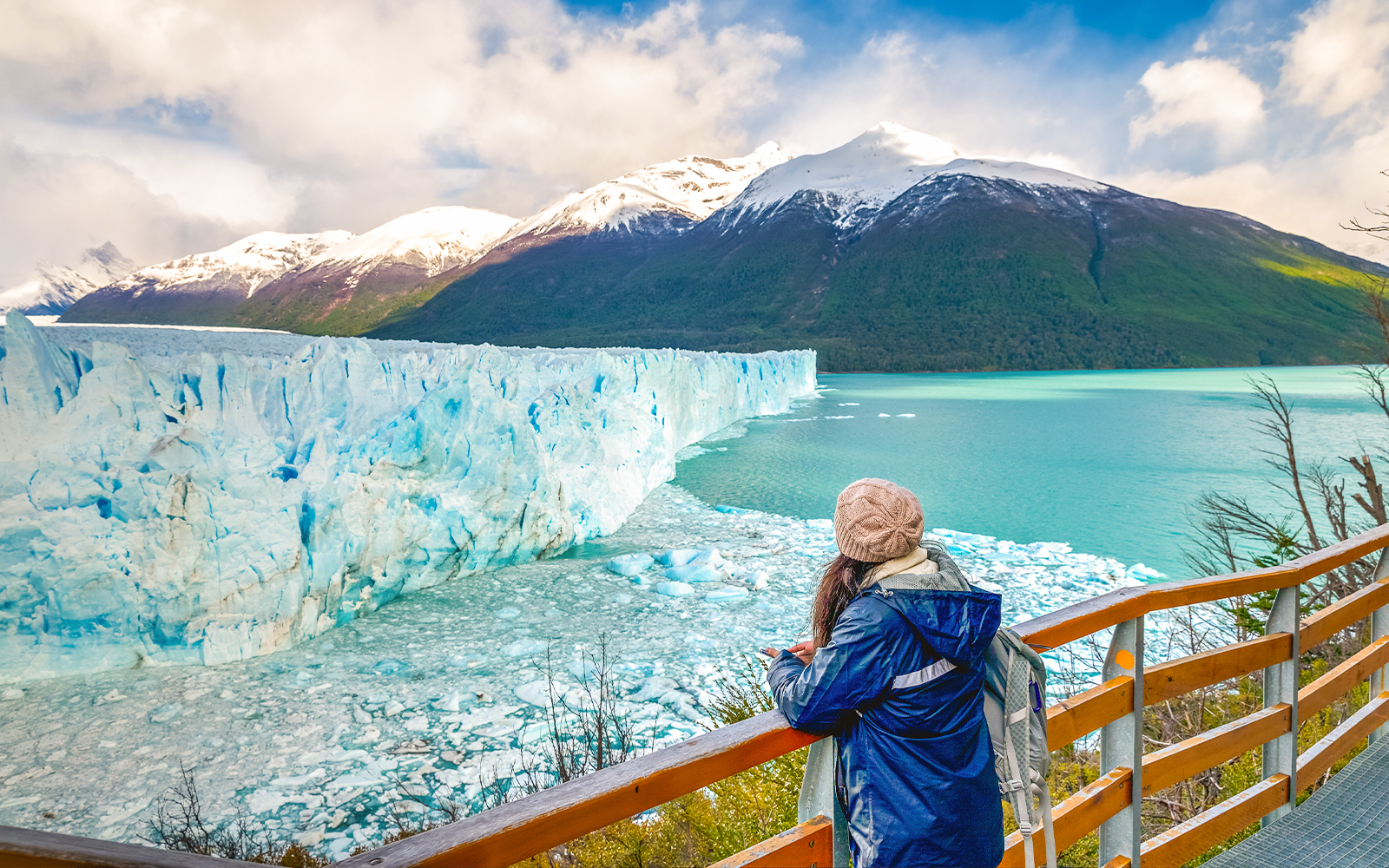 Visitor observing Perito Moreno Glacier from viewing deck in Argentina.