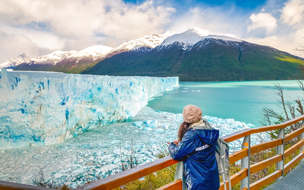 Visitor observing Perito Moreno Glacier from viewing deck in Argentina.