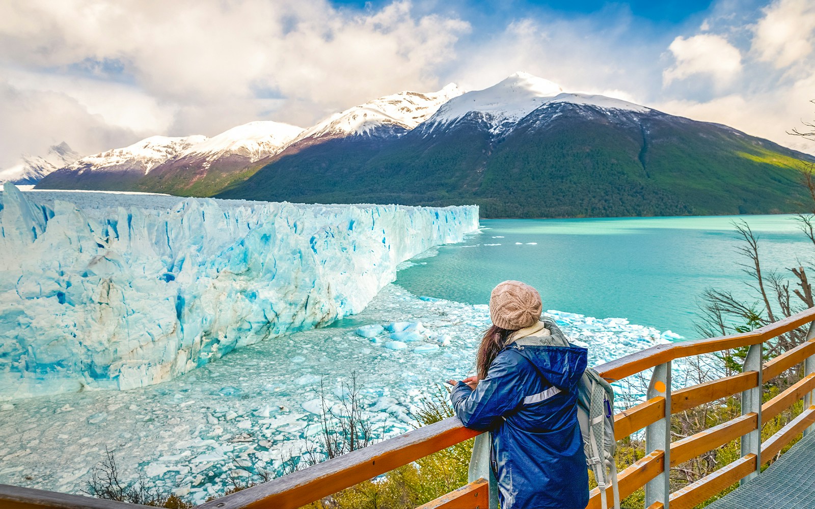 Visitor observing Perito Moreno Glacier from viewing deck in Argentina.