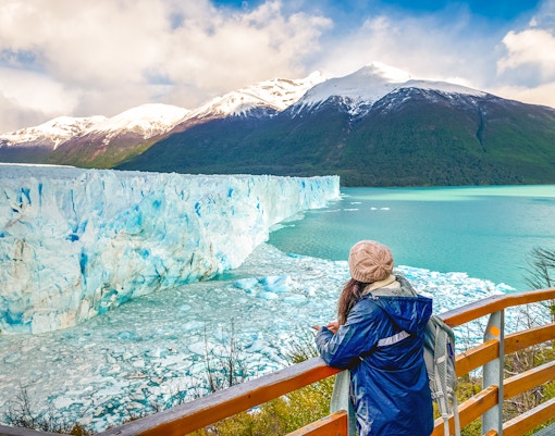 Visitor observing Perito Moreno Glacier from viewing deck in Argentina.
