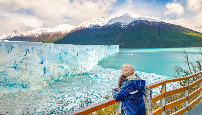 Visitor observing Perito Moreno Glacier from viewing deck in Argentina.