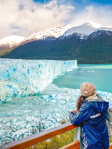 Visitor observing Perito Moreno Glacier from viewing deck in Argentina.