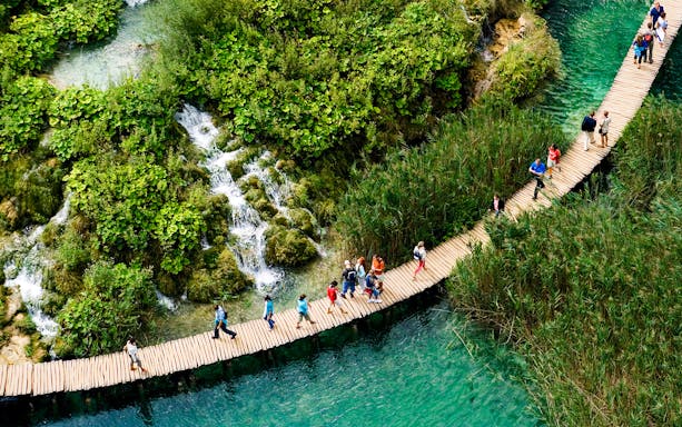 Plitvice Lakes cascading waterfalls and lush greenery in Croatia.
