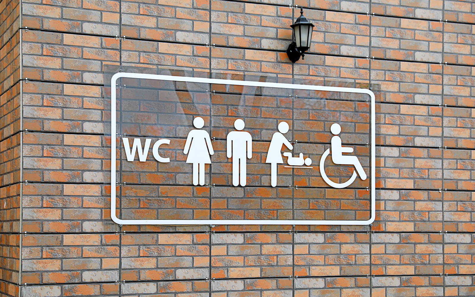 Public restroom sign with male and female symbols