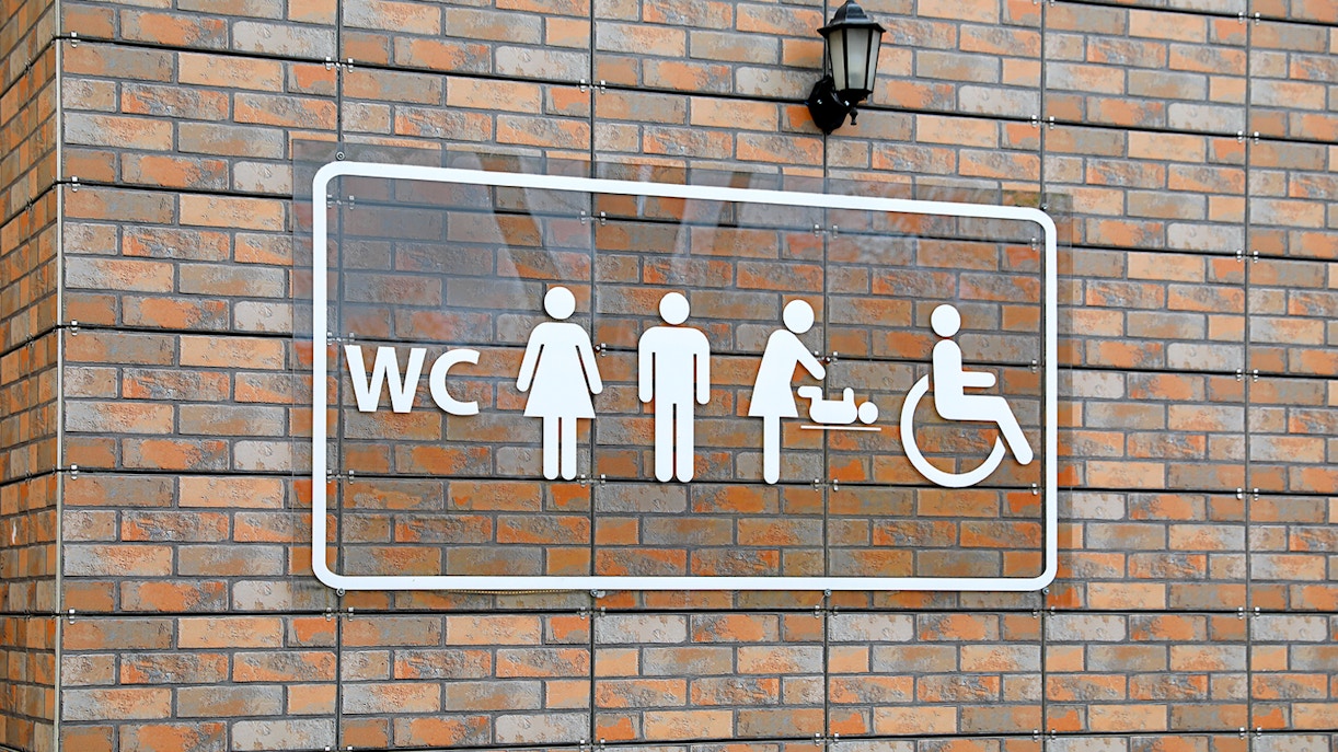 Public restroom sign with male and female symbols
