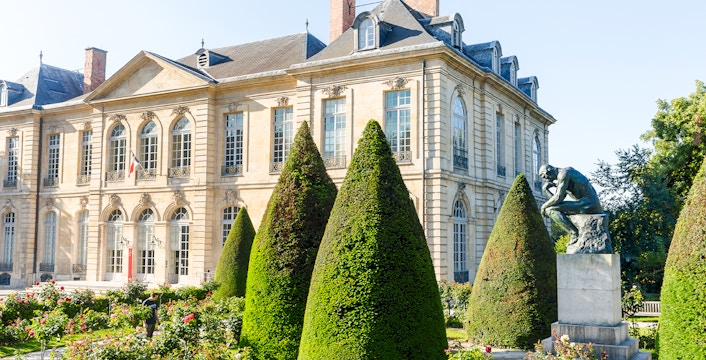 Rodin Museum garden with The Thinker sculpture and historic building in Paris.