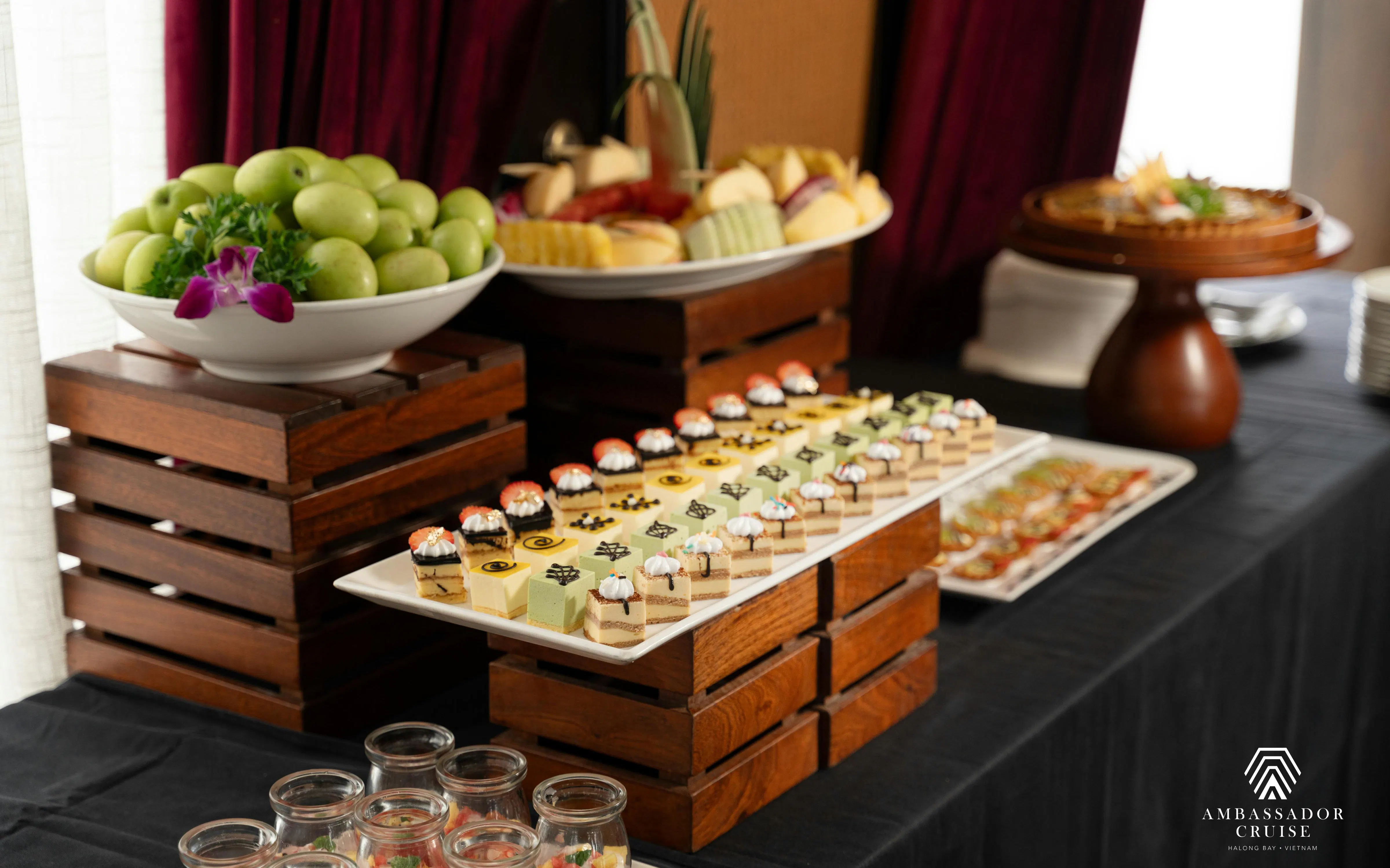Buffet spread with desserts and fruits on Ha Long Bay 5-Star Ambassador Cruise.