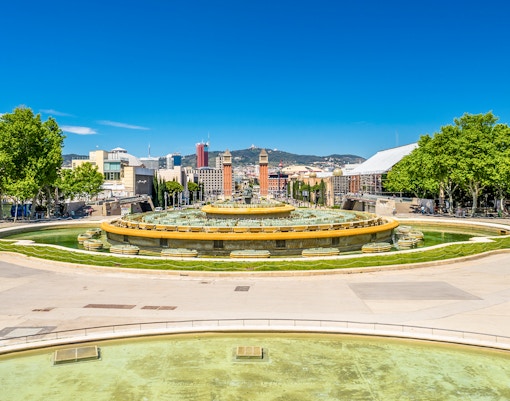 Panoramic view of Barcelona cityscape from Montjuïc Hill, showcasing iconic landmarks.
