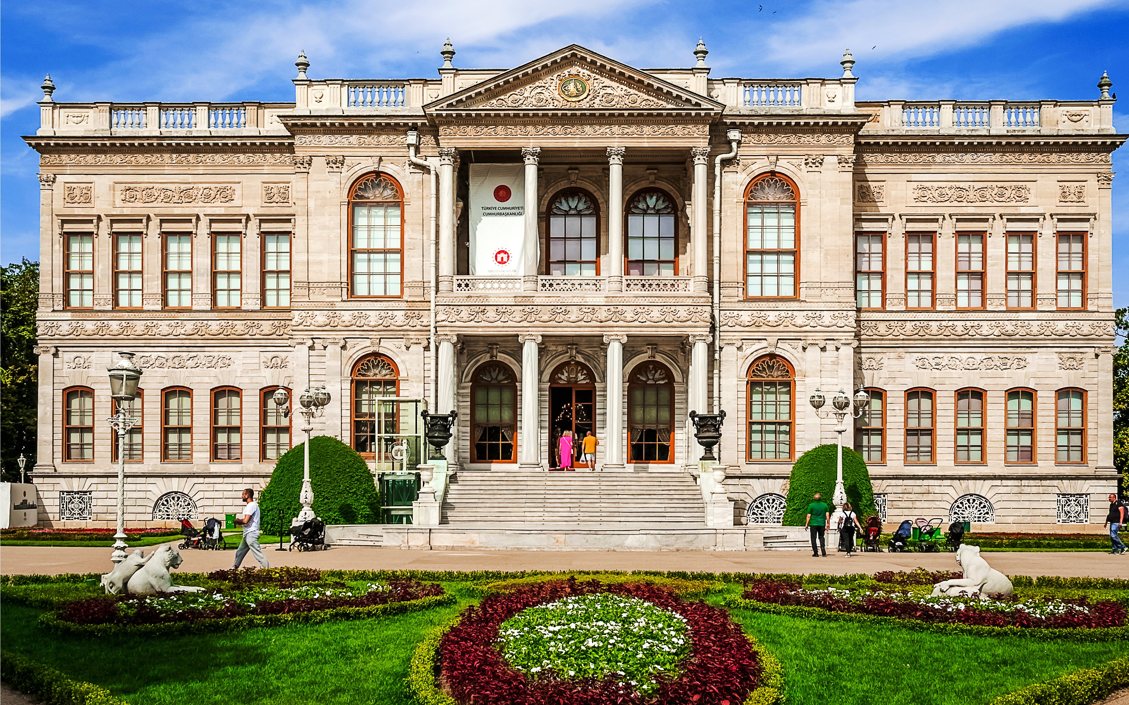 Dolmabahce Palace facade with ornate architecture and garden in Istanbul.