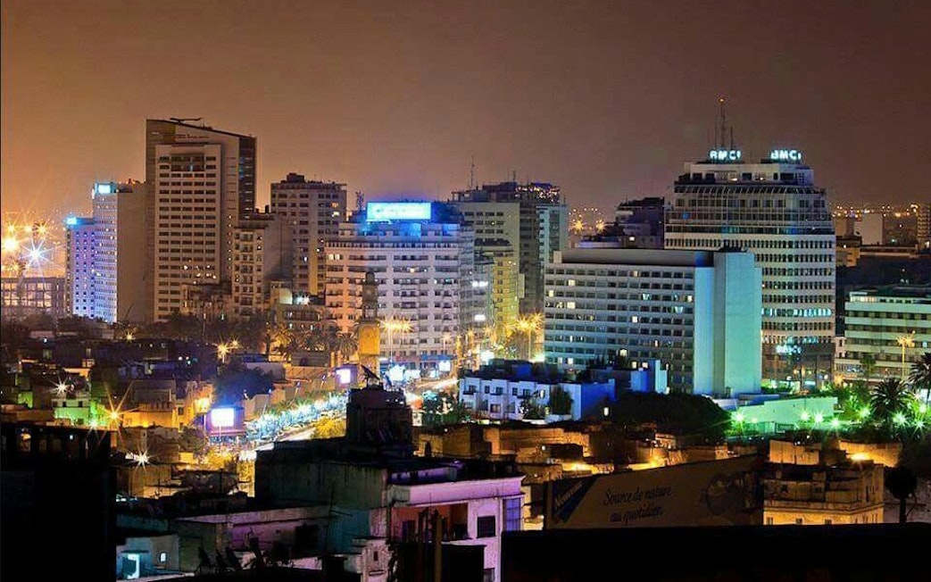 Casablanca cityscape at night with illuminated buildings.