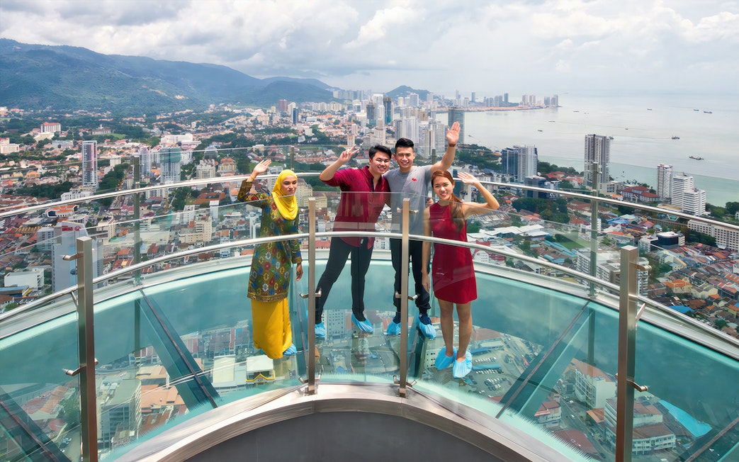 Visitors enjoying the view from Rainbow Skywalk and Observatory Deck in Penang, Malaysia.