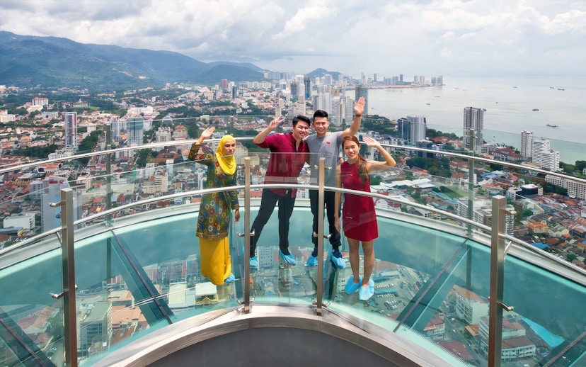 Visitors enjoying the view from Rainbow Skywalk and Observatory Deck in Penang, Malaysia.