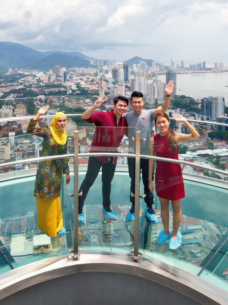 Visitors enjoying the view from Rainbow Skywalk and Observatory Deck in Penang, Malaysia.