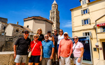 Group of tourists in front of Diocletian's Palace bell tower, Split City Tour.