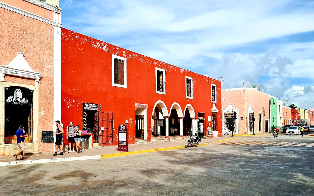 Vibrant street scene with colorful colonial buildings in Valladolid, Yucatán, Mexico.
