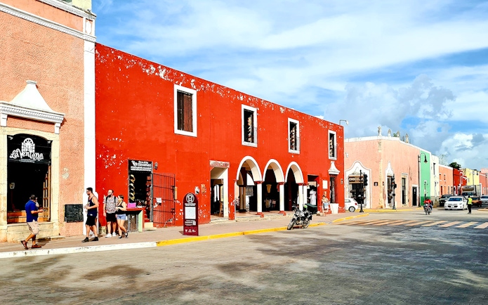 Vibrant street scene with colorful colonial buildings in Valladolid, Yucatán, Mexico.