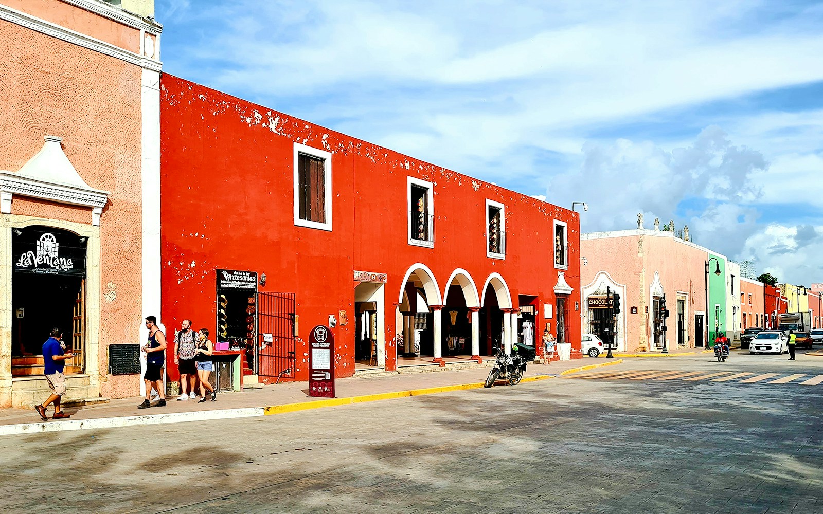 Vibrant street scene with colorful colonial buildings in Valladolid, Yucatán, Mexico.