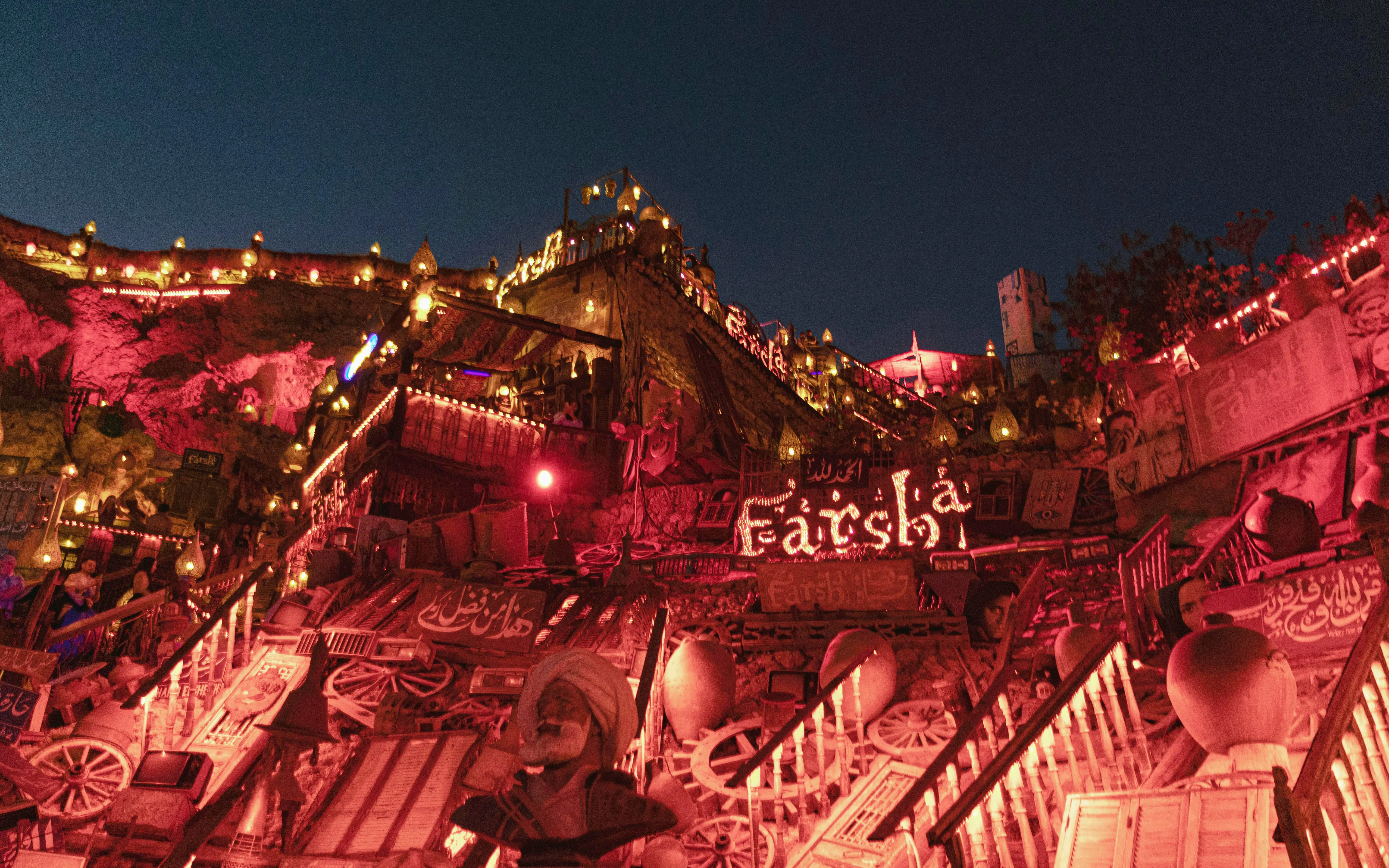 Farsha Cafe illuminated at night, Sharm El Sheikh, Egypt, with vibrant decor and lights.