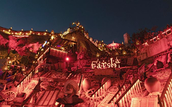 Farsha Cafe illuminated at night, Sharm El Sheikh, Egypt, with vibrant decor and lights.