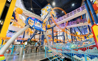 Berjaya Times Square Theme Park entrance with colorful roller coaster and vibrant decor.