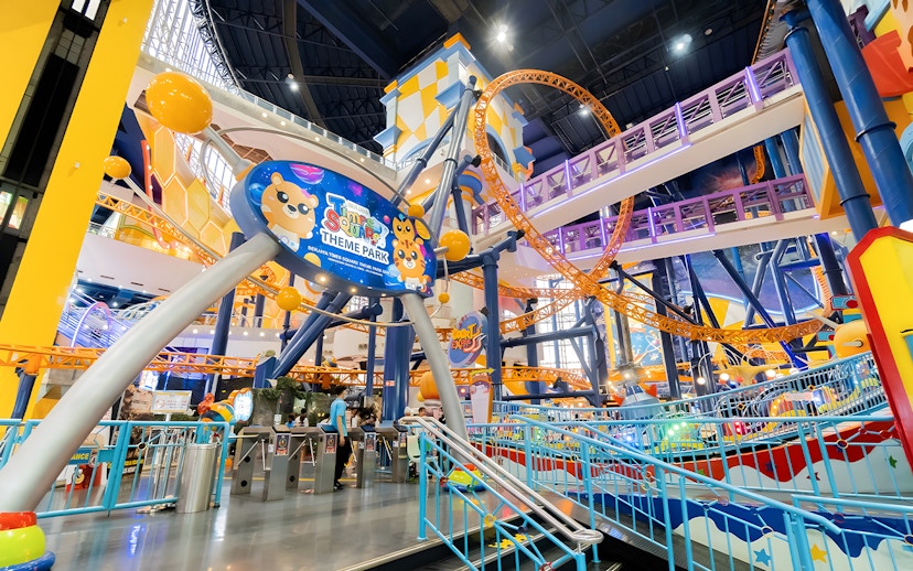 Berjaya Times Square Theme Park entrance with colorful roller coaster and vibrant decor.
