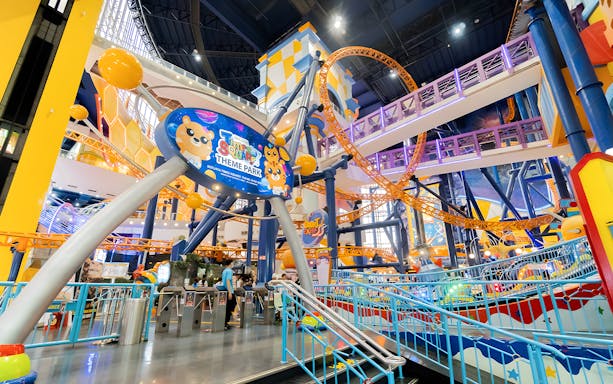 Berjaya Times Square Theme Park entrance with colorful roller coaster and vibrant decor.