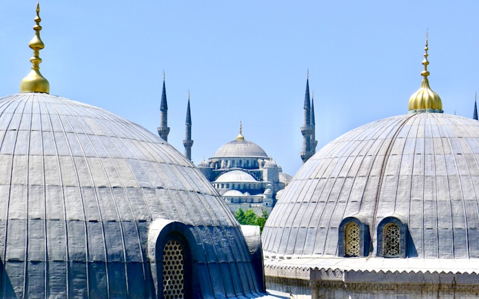 Rooftop view of the Blue Mosque's domes and minarets in Istanbul.